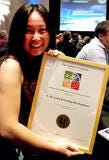 photo of woman holding award