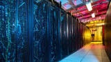 A blue and orange image of a hallways with servers.