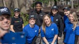 Employees smiling in group at volunteer event