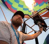 View of man inflating hot air balloon.