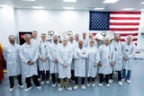 group of workers with american flag in the background