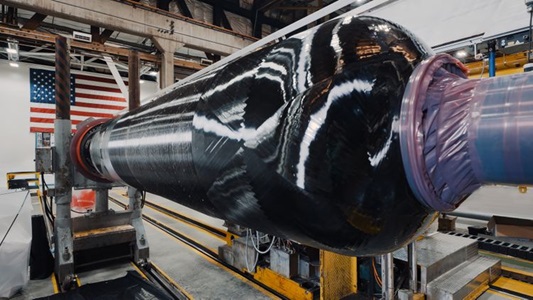 Northrop Grumman performs the insulation layup and composite case wind of its 2024 SMART Demo solid rocket motor case. The innovative case design and build, scheduled to complete in August, will be structurally tested in September and complete static test in December as part of the company’s second annual demonstration. (Photo Credit: Northrop Grumman) Northrop Grumman Completes First Use of Modular Tooling for Large Solid Rocket Motor Case