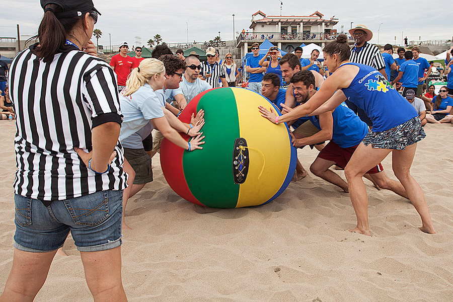 two teams competing in game on the beach