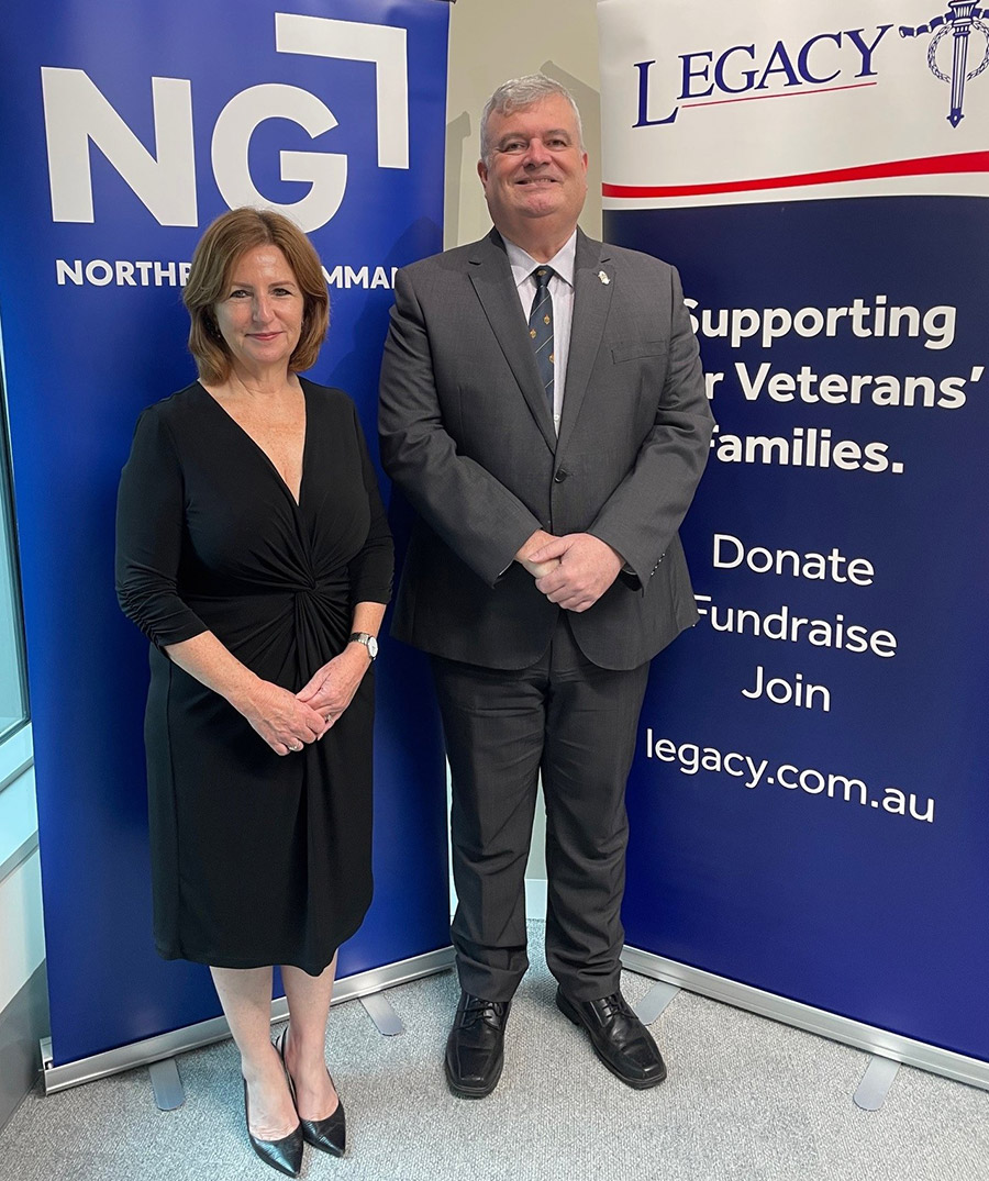 two people standing in front of banners