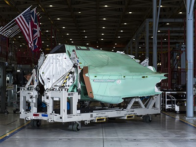 fighter jet fuselage coming off assembly line.