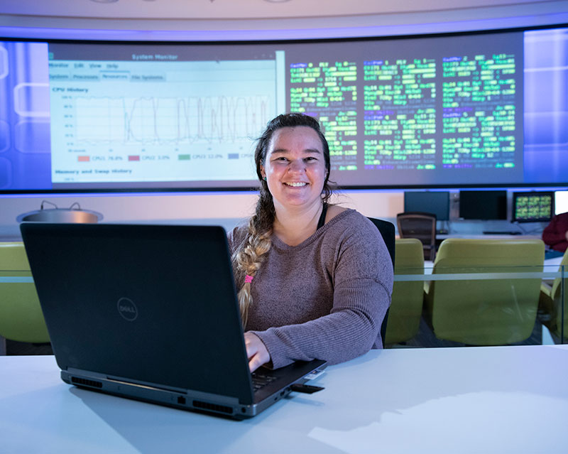 smiling female working on a laptop