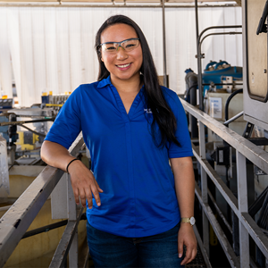 employee smiling with safety glasses on