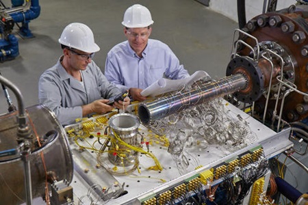 two people working together in factory