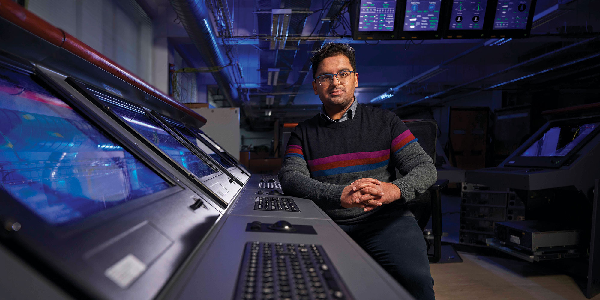 man leaning on computer console