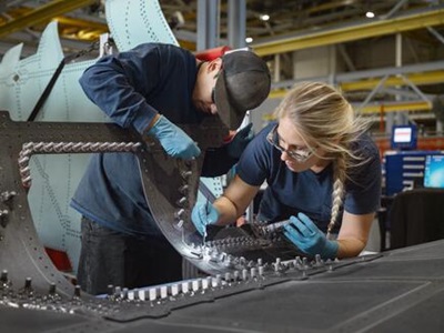 two people working on the F-35 assembly line