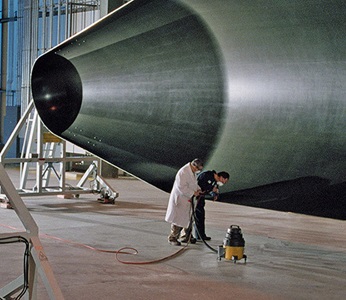 two technicians working on aircraft parts.