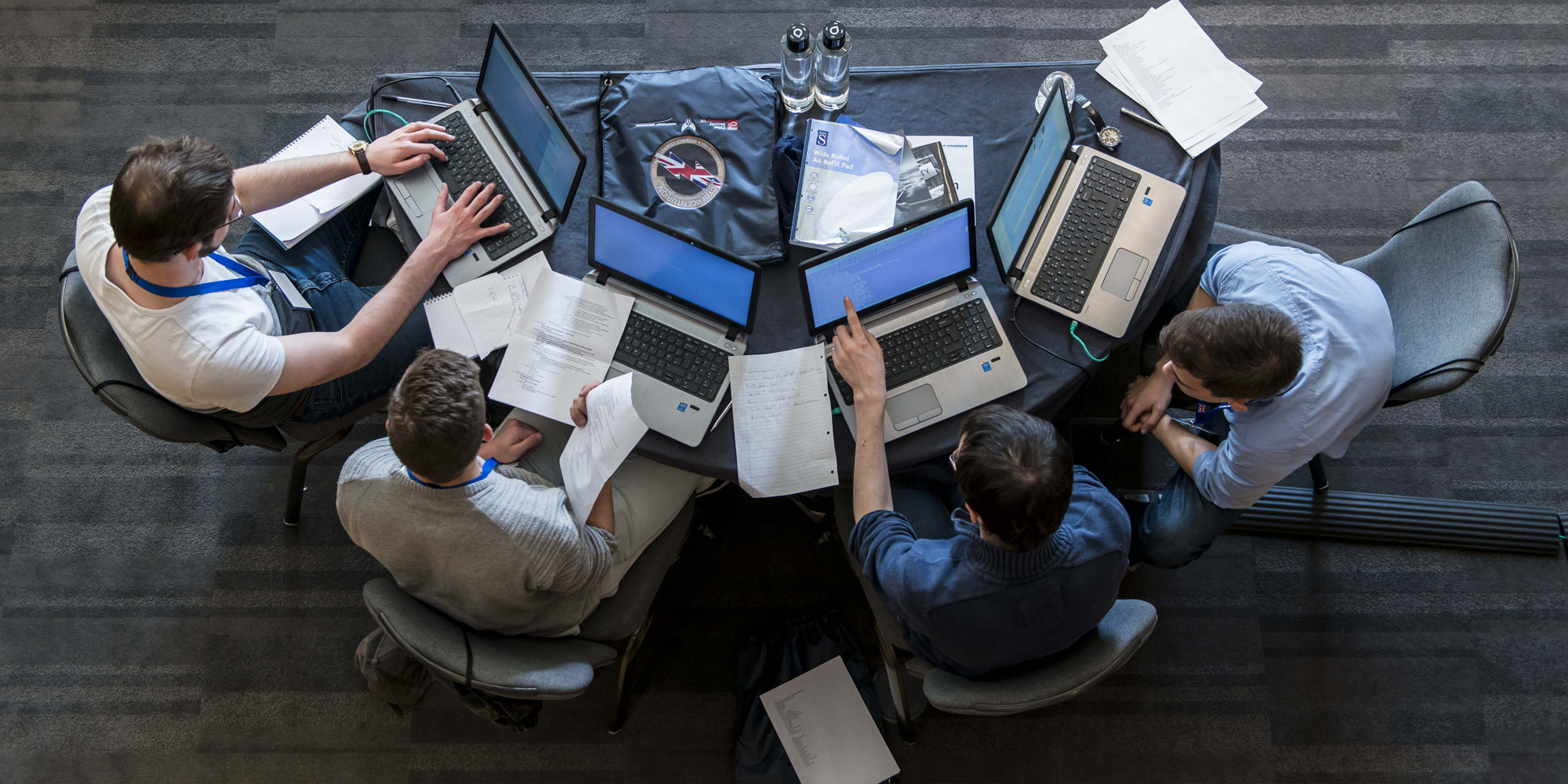 Five men on laptops at Cyber Centurion competition