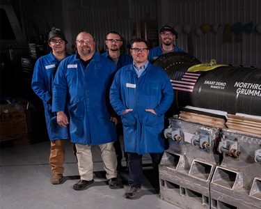Group of men in blue jump suits