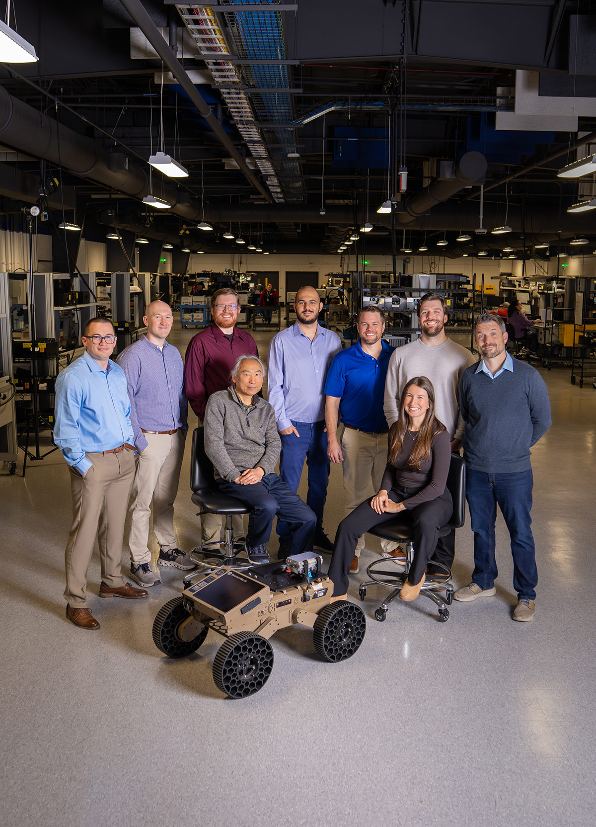 group of workers and drone in large warehouse