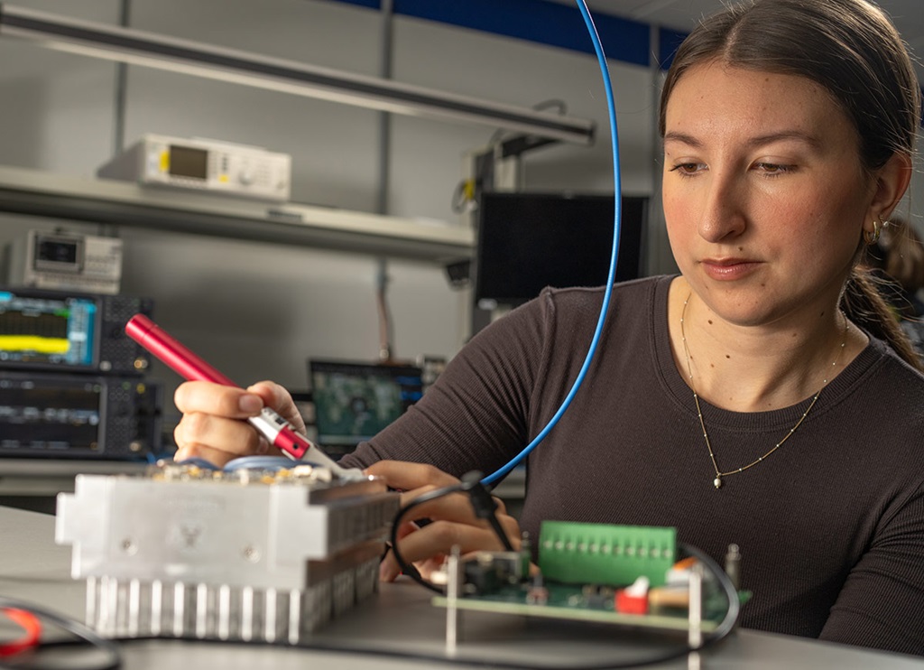 young woman soldering electronics