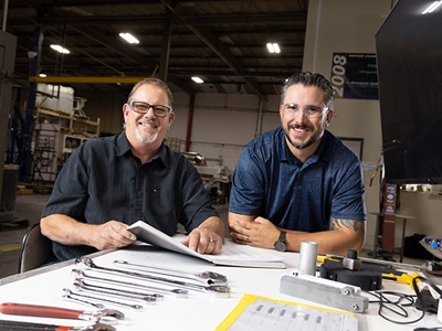 two men at a drafting table
