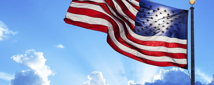 U.S. flag flying in blue sky