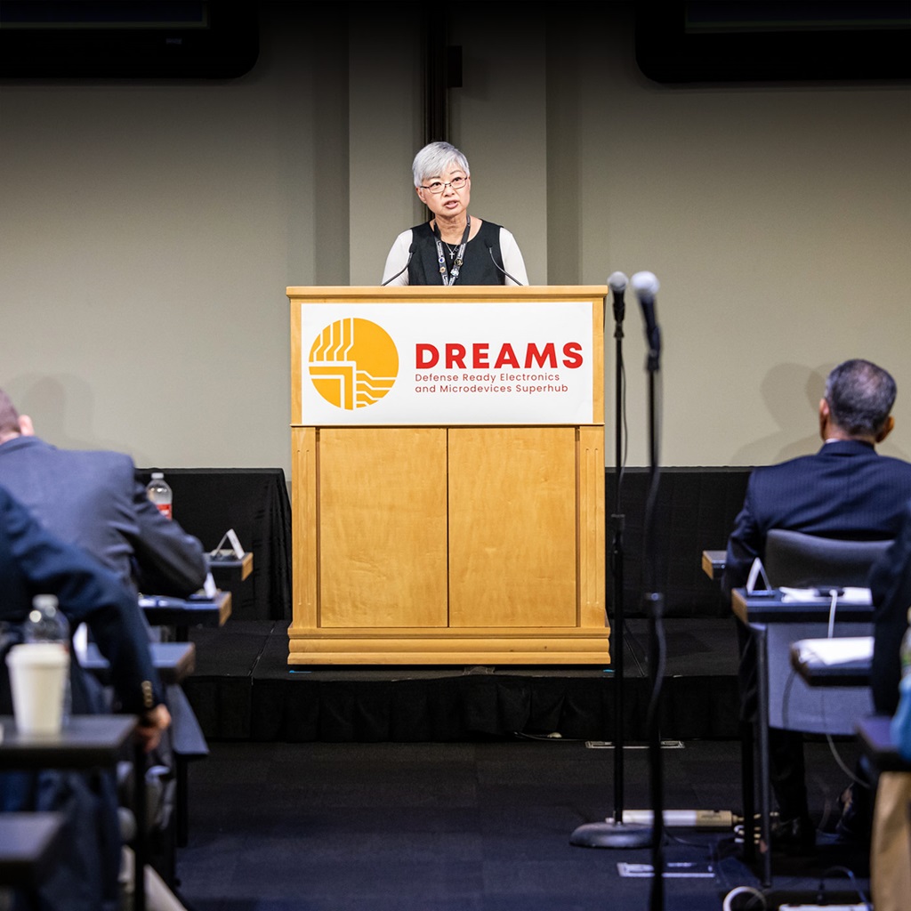 Woman speaking at podium in large conference room