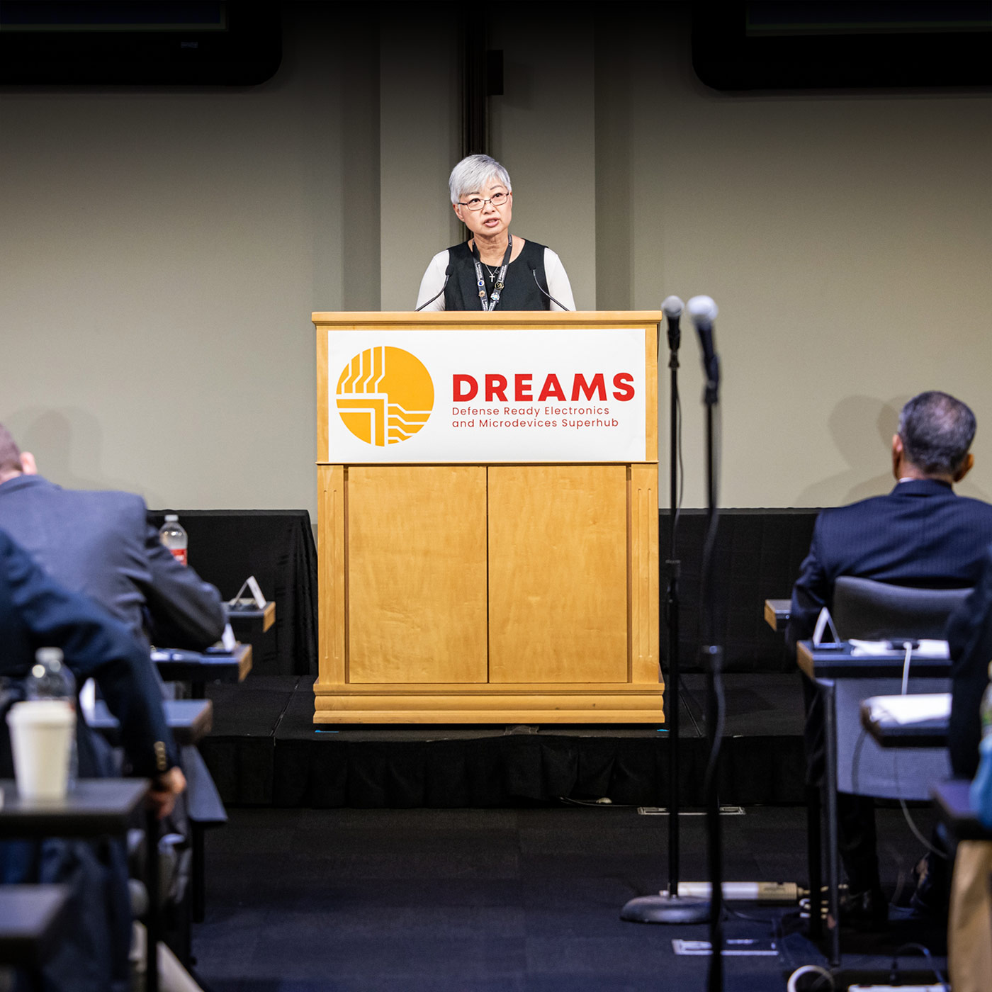 Woman speaking at podium in large conference room