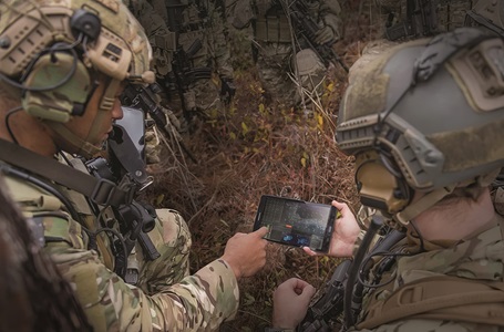 soldiers pointing to handheld electronic device