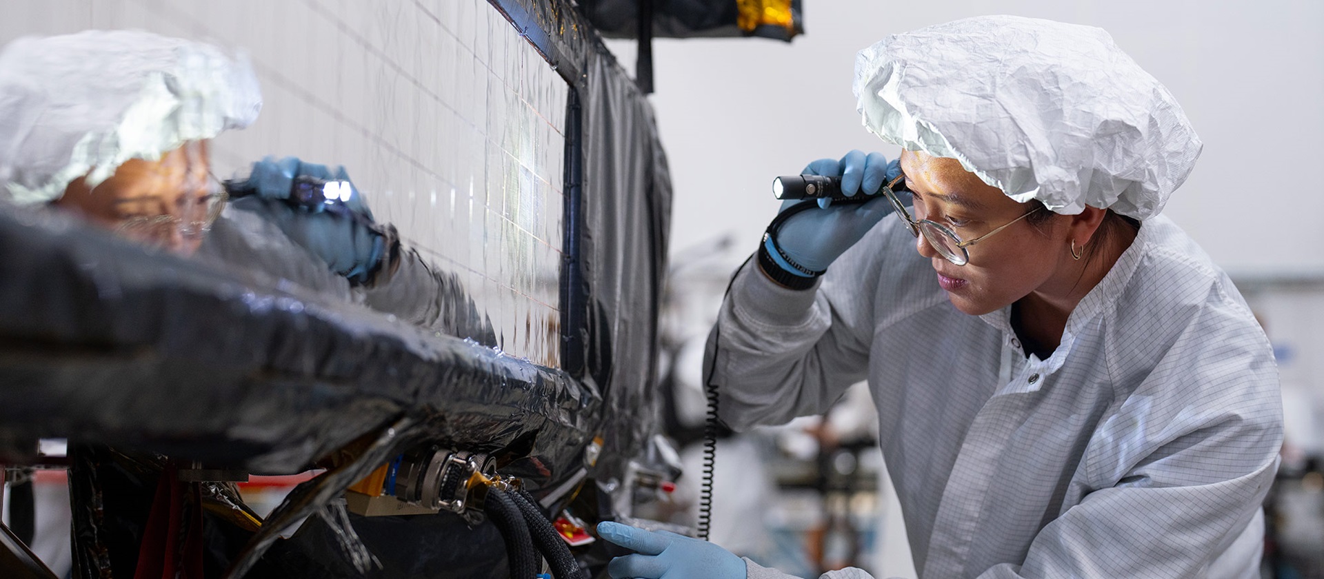 Female engineer working on ASBM satellite