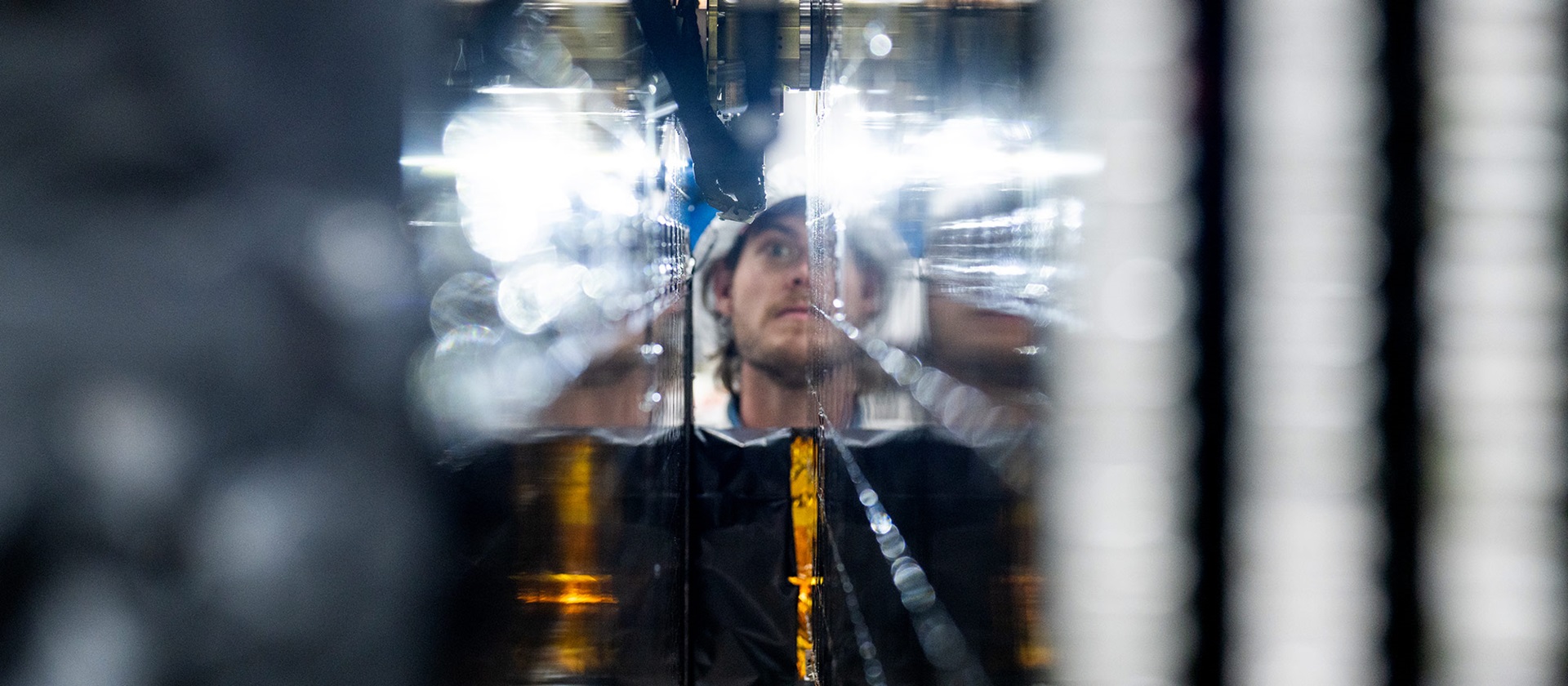 Reflection of man working on ASBM satellite