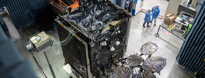 satellite being worked by technicians.