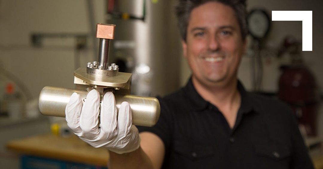 man in black shirt holding a cryocooler