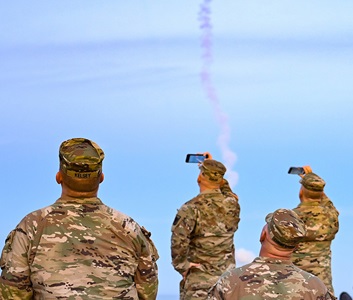 military personnel watching a missile flight test