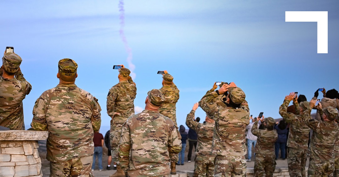 military personel watching a missile launch