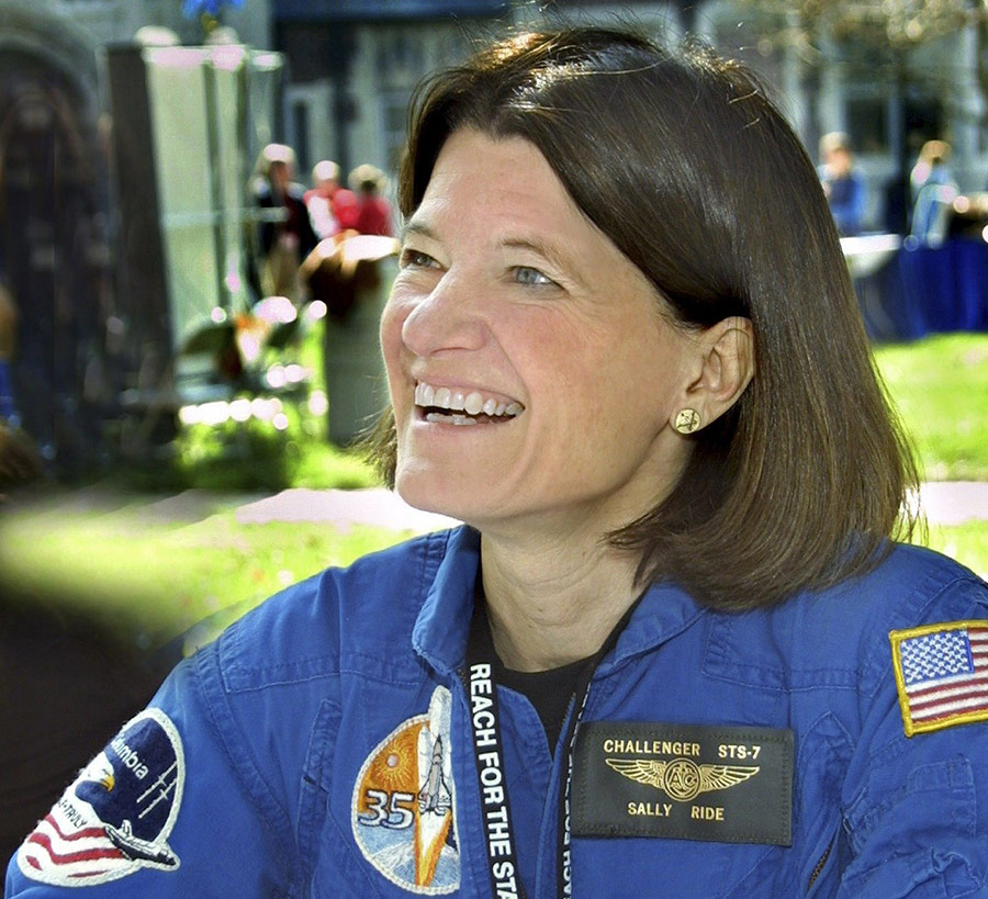 woman in flightsuit smiling