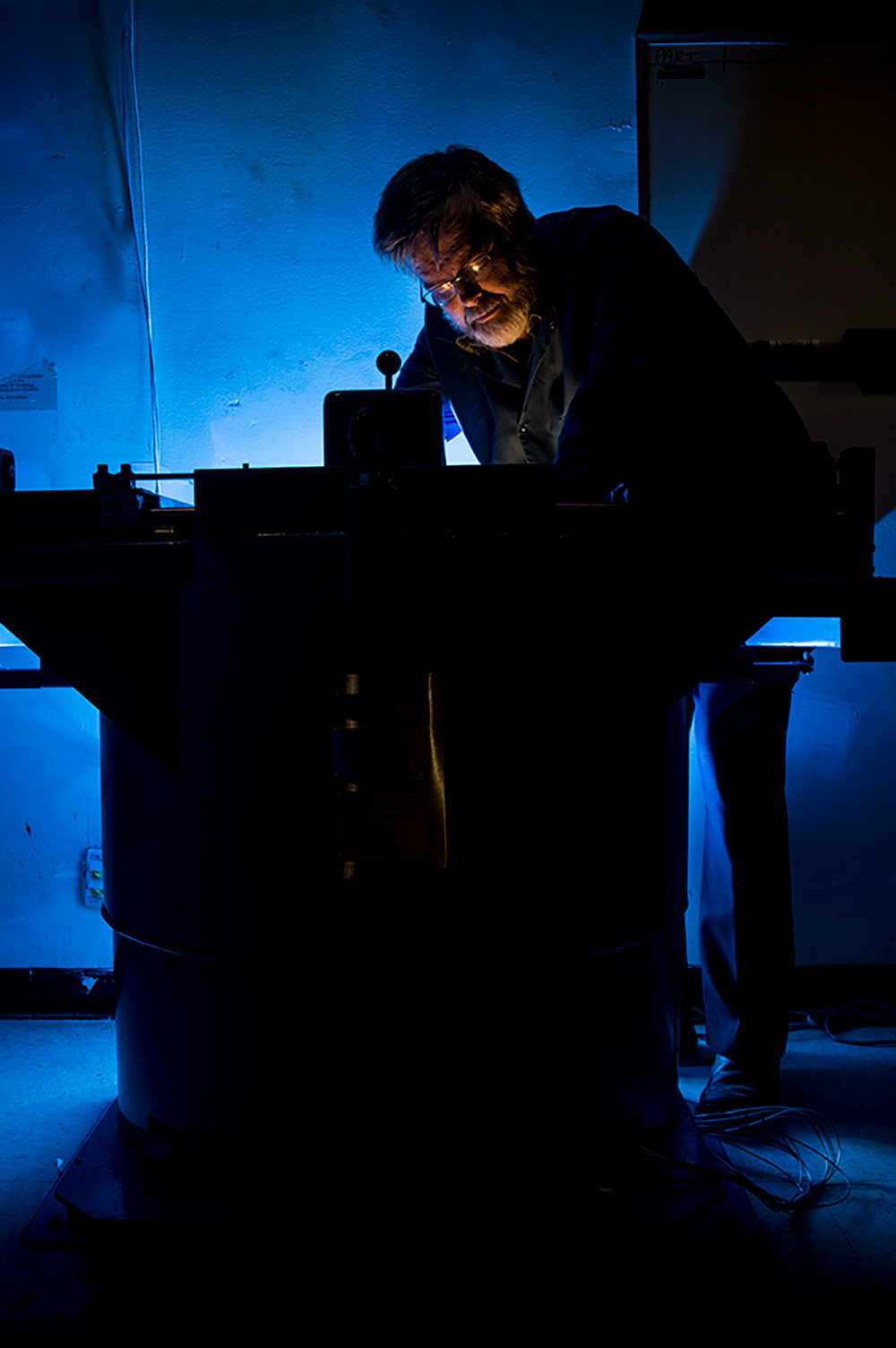 silhouette of man working on a machine