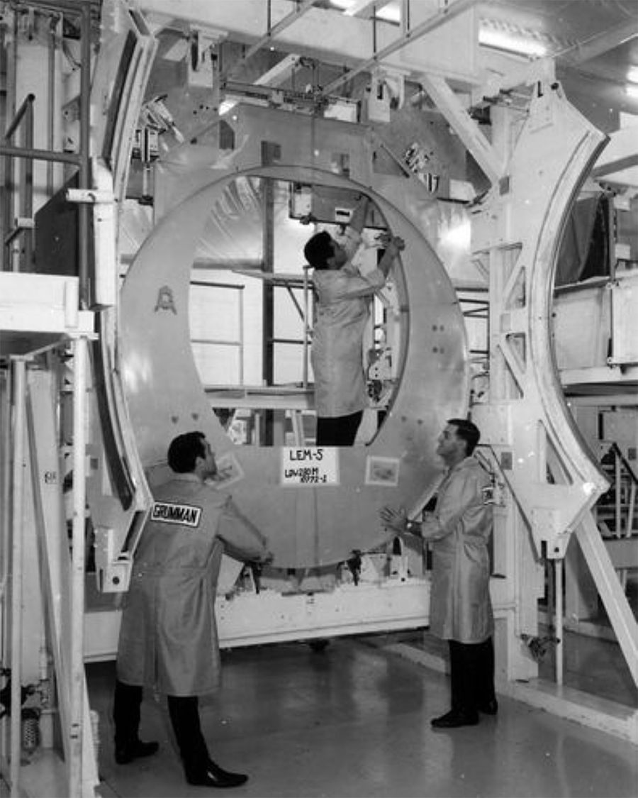 three technicians working on high tech equipentment