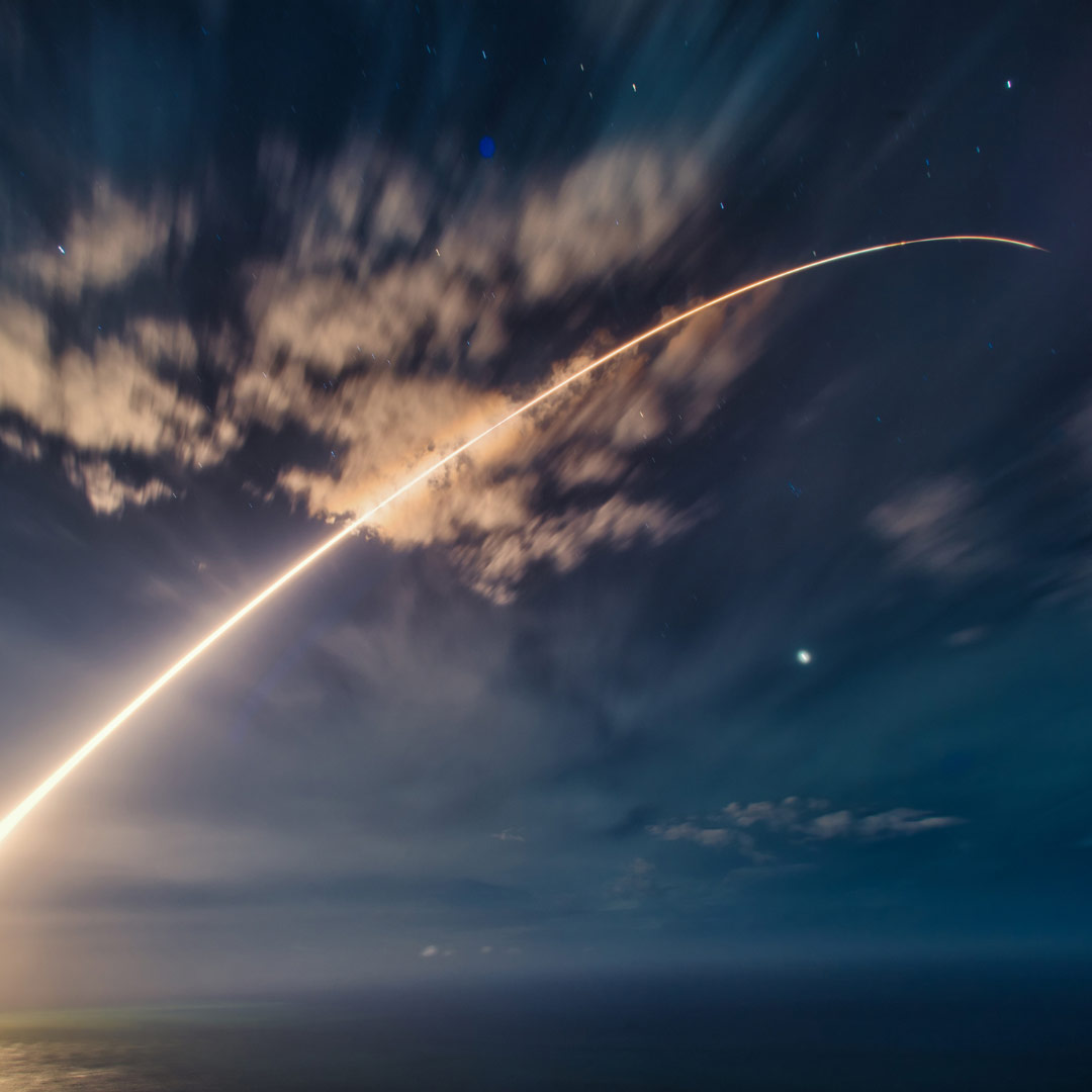 Missile launch across cloudy night skies