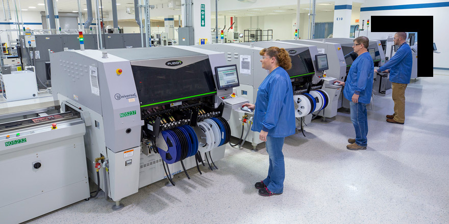 three technicians working in a factory