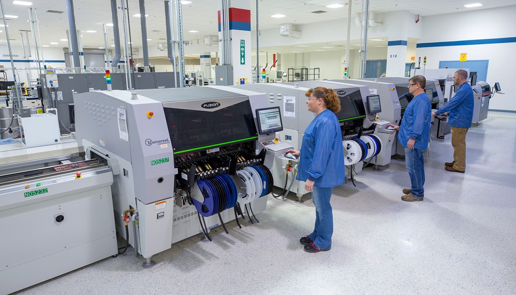 three technicians working in a high-tech factory.