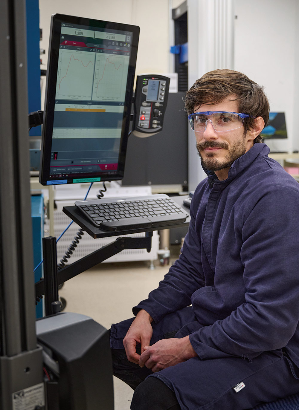 man wearing goggles in front of computer