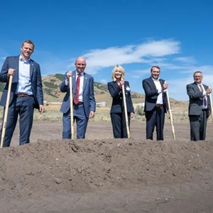 five executives with shovels at a groundbreaking event