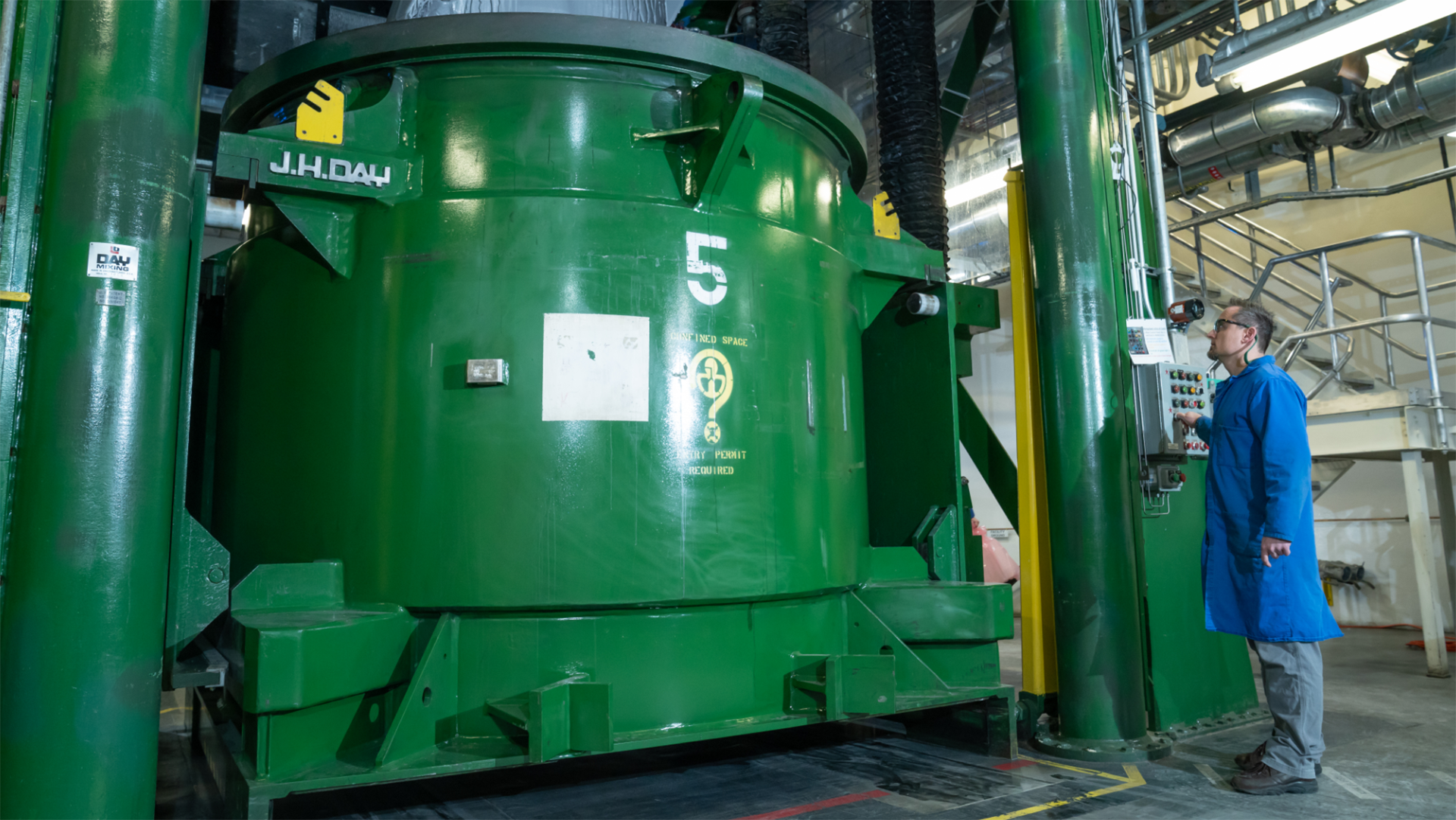 green tank and worker inside the Promontory facility