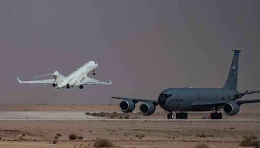 military jet lifting off in desert