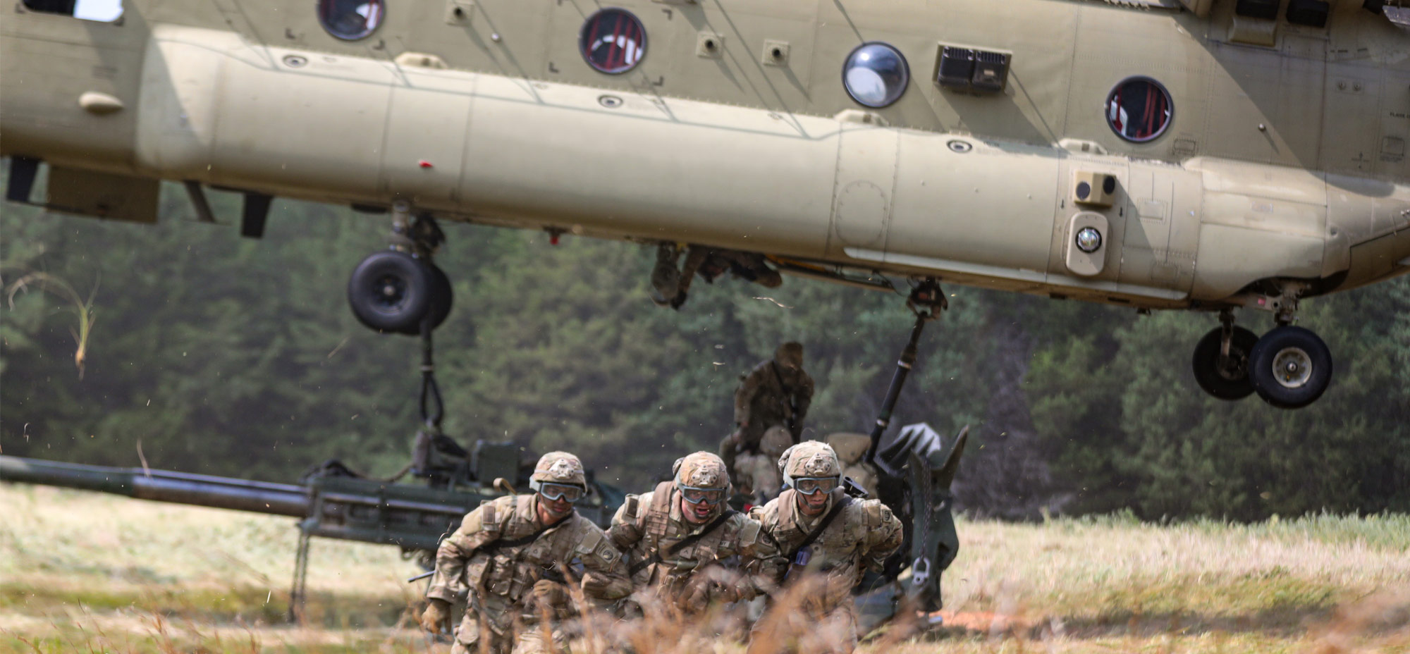 soldiers conducting conduct sling load operations from helicopter