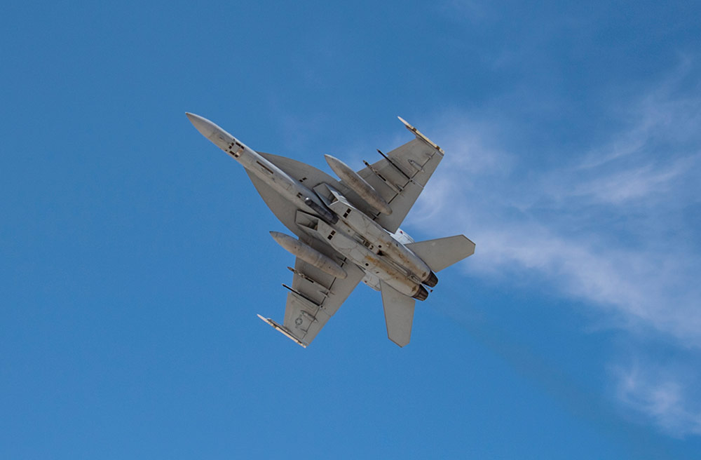 F/A-18 jet flying in blue sky