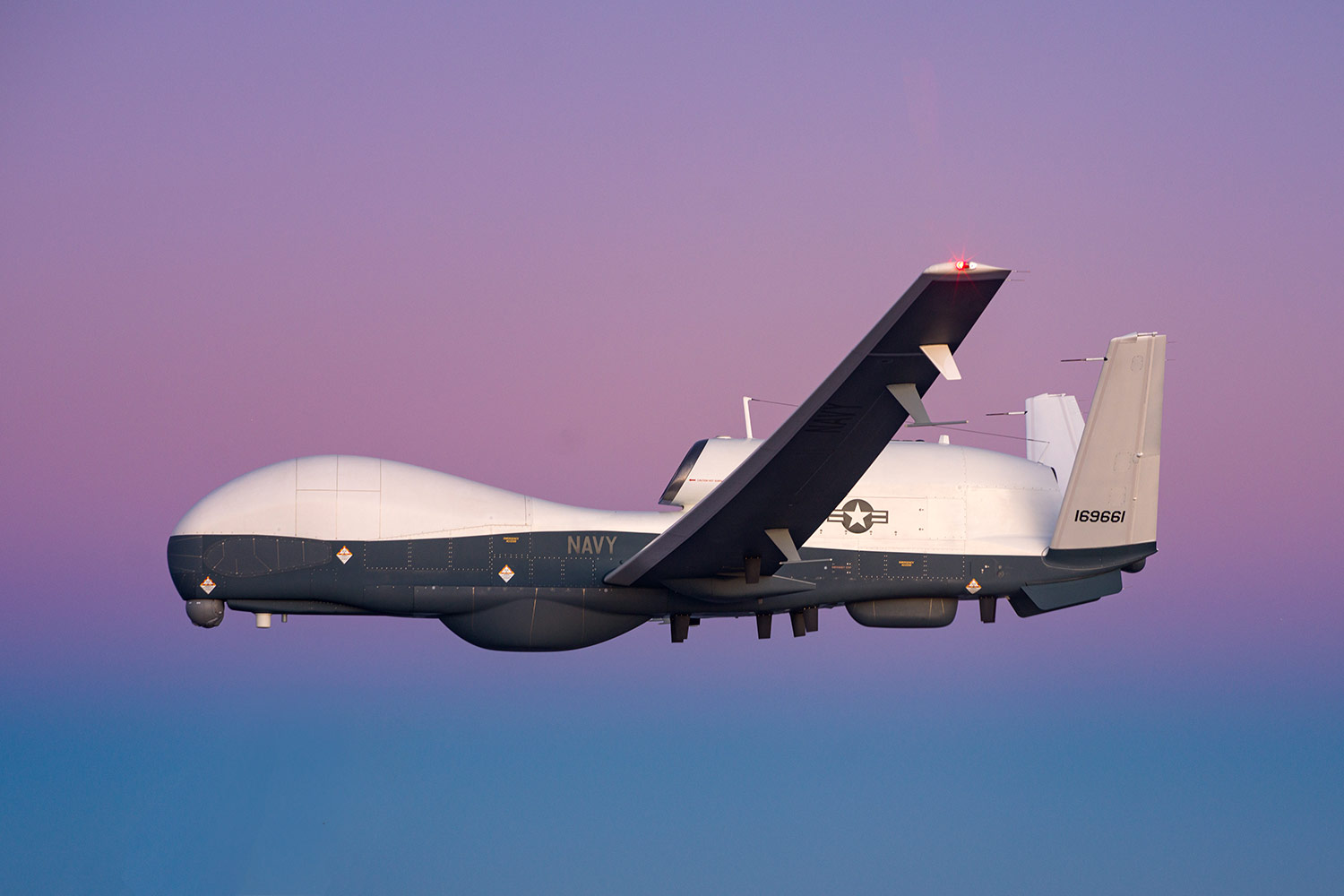 MQ-4C Triton in Flight at sunset