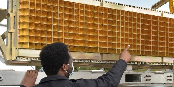 Multifunction Sensors – hero A man wearing a Northrop Grumman jacket points to a sensor panel