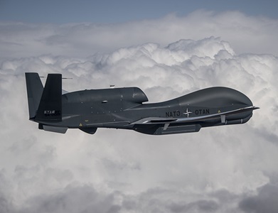 US military aircraft inflight above clouds