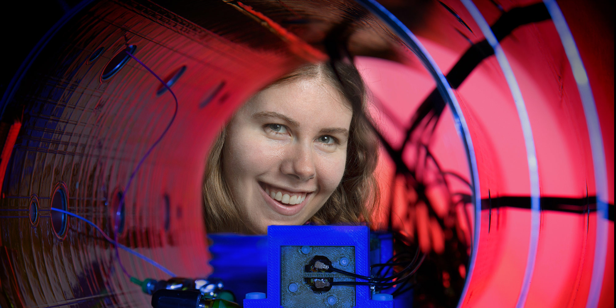 women looking through instrument that measures magnetic fields