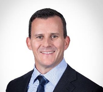 headshot of smiling white male in suit