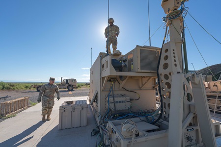 Military personnel outside on equipment. 