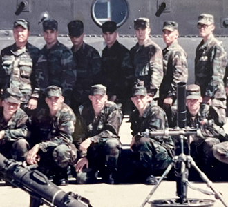 US soldiers standing in front of a helicopter