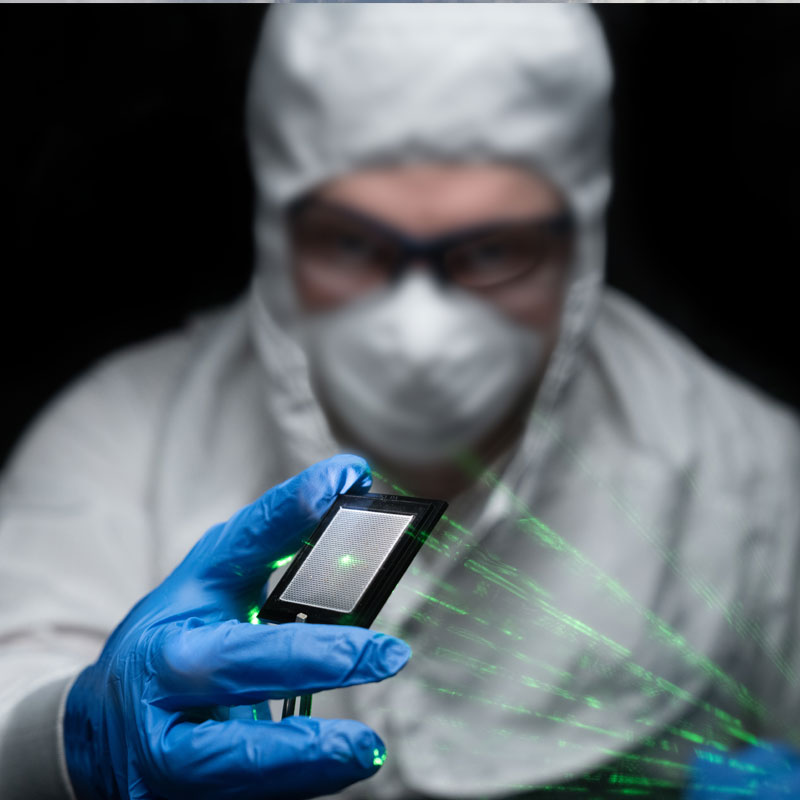 Microelectronics technician testing with lasers